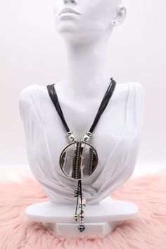 This necklace features a silver metallic circle pendant that is elegantly adorned with multiple dangling stones, creating a sparkling effect. It hangs from a multi-strand black rope, giving the piece a bold and contemporary look. Length: 18” (18 extensions) Pendant: 2.15” (Length) 2.15” (Width) Closure: Lobster Claw Clasp Material: Brass with Silver Plating with Rhodium Coating Lead Free and Hypoallergenic Black Metal Circle Necklaces, Black Metal Circle Necklace, Black Circular Metal Necklace, Black Metal Circular Necklace, Black Circle Metal Necklaces, Black Rope Necklace, Black Rope, Rope Necklace, Light Black