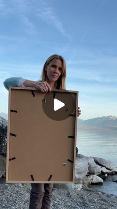 a woman holding up a cardboard box with holes in it and an arrow pointing to the side