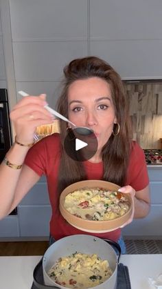 a woman holding a bowl of food in front of her face