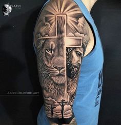 a man with a cross and lion tattoo on his arm