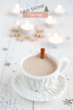 a cup of hot chocolate with cinnamon sticks in it