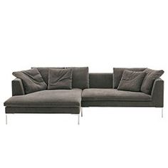 a gray couch with pillows on top of it