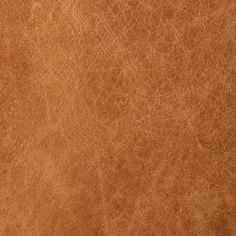 a brown leather texture background or wallpaper that looks like it has been used for many years