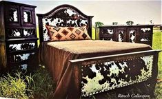 an advertisement for a bed and dressers in the grass with cow print on them