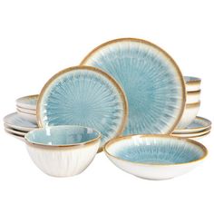 a blue and white dinner set on a white background