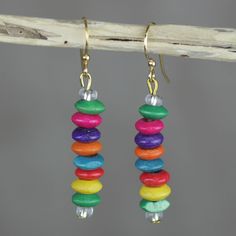 earrings with multi colored beads hanging from them