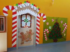 three decorated christmas doors in front of a yellow wall with candy canes on it