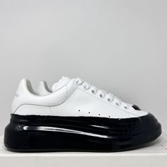 Alexander McQueen Men's Oversized Leather Dipped Sneakers  100% Original & Authentic Guaranteed  Size: 39 EU / 6 US Color: Black White Style Code: 645864 WHZ4M 9061 Brand New In Box With Original Extra Laces Leather upper Round toe Lace-up vamp Rubber sole Made in Italy All our items are 100% Authentic Guaranteed  Item pictured is item being sold. Please review all pictures carefully before purchasing. Please feel free to message me with any questions! International Buyers: Please send us a message to inquire about shipping options to your country. Custom Low-top Patent Leather Sneakers With White Sole, Classic Low-top Patent Leather Sneakers, Custom Low-top Patent Leather Sneakers For Streetwear, Patent Leather Sneakers With Contrast Sole, Low-top Platform Sneakers With Leather Sole For Streetwear, Casual Patent Leather Sneakers With Leather Sole, Platform Sneakers With Leather Sole For Streetwear, Alexander Mcqueen Oversized Sneaker, Alexander Mcqueen Men