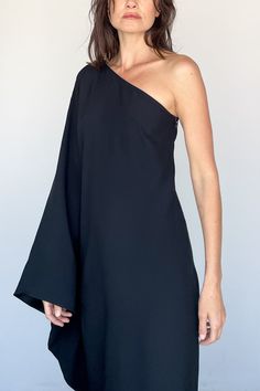 Balear Dress in Black from Taller Marmo Sleek one shoulder black crepe dress Long sleeve connects to side of dress creating a striking hole detail when open Single long sleeve, hidden side zip Attached neck tie can be left hanging loose down the back or wrapped around neck Relaxed, straight silhouette 78% acetate, 22% viscose Made in Italy Model Measurements & Item Sizing: Model Height: 5'8” Model size: US 2 / S / 26 Size shown on model: 38 Sizing: 36 = XS 38 = S 40 = M 42 = L Black Crepe Dress, Taller Marmo, Swim Jewelry, Brother Vellies, Hang Loose, Back Jewelry, Ring Pendant Necklace, Dress Long Sleeve, Crepe Dress