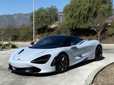 a white sports car is parked in the driveway