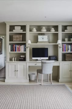 a home office with built in bookshelves and desk