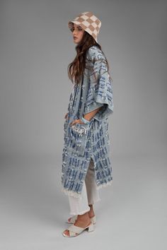 Elevate your everyday look with the Denim Fringe Short Sleeve Long Jacket. This soft denim jacket features short sleeves, two deep pockets, and a long, flattering silhouette. Unique yarn embellishments add texture and pattern, while fringe detailing at the hem creates a modern touch. It's your transitional weather must-have, perfect for layering over dresses, jeans, or work attire. -Made In India Casual Denim Outerwear With Fringe, Yarn Embellishments, Trendy Blue Fringed Outerwear, Denim Fringe Shorts, Denim Long Sleeve Outerwear With Fringe, Fitted Fringe Long Sleeve Denim Jacket, Trendy Long-sleeved Distressed Denim Jacket, Denim Fringe, Texture And Pattern