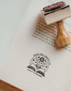 a rubber stamp sitting on top of an open book