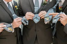 three men in suits are tying their ties