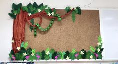 a bulletin board decorated with paper flowers and leaves