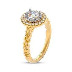 a gold engagement ring with an oval center surrounded by small round cut diamonds on the band