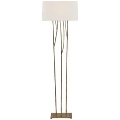 a lamp that is on top of a stand with a white lampshade over it