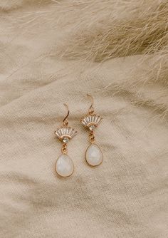 Our Aria Moonstone Earrings are simply beautiful. Made with genuine rainbow moonstone, they're made to stand out. They were designed for the classic, yet bohemian chic bride who wants a dainty look on her wedding day.FEATURES Genuine Rainbow Moonstone Teardrop set in gold vermeil or sterling silver Choice of Materials: 16k gold, rose gold, or sterling silver Ear wire is sterling silver or gold filled 100% nickel free, great for sensitive ears Bohemian Teardrop Jewelry For Wedding, Teardrop Gemstone Chandelier Earrings For Wedding, Wedding Gemstone Teardrop Dangle Earrings, Gemstone Dangle Teardrop Earrings For Wedding, Gemstone Teardrop Dangle Earrings For Wedding, Dangle Teardrop Gemstone Earrings For Wedding, Wedding Dangle Teardrop Gemstone Earrings, Elegant Moonstone Dangle Crystal Earrings, Elegant Gold Crystal Earrings With Moonstone