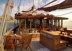 a table and chairs on the deck of a boat