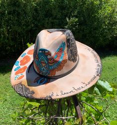 "FREEBIRD" Tan color hat, hand painted flowers, Falcon & "if i leave here tomorrow, would you still remember me ?" southwestern design 4" wide brim women's hat Includes removable hat band...hat has been burned & paint weathered.. burned fabric added for weathered distressed look...under hat has painted flowers  Make an any outfit stylish with this hand painted one of a kind walking art. Premium thick texture paint. Polyester material Size 59cm   Brim: 4" Hat Height 5"  Please read hat measuremen Adjustable Wide Brim Hand Painted Hats, Hand Painted Brown Wide Brim Hat, Bohemian Hand Painted Adjustable Hat, Adjustable Bohemian Hand Painted Hat, Adjustable Brimmed Hand Painted Fedora, Hand Painted Adjustable Brimmed Fedora, Hand Painted Flat Brim Hat For Rodeo, Bohemian Fedora With Hand Painted Curved Brim, Bohemian Hand Painted Fedora With Curved Brim