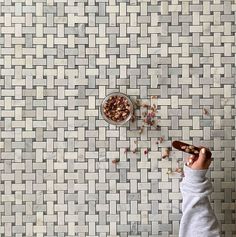 a person is eating cereal on the floor