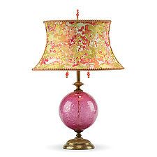 a lamp that is sitting on top of a table with a pink ball underneath it