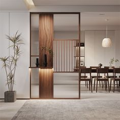 a dining room with an open door leading to the kitchen and living area, along with a large rug on the floor