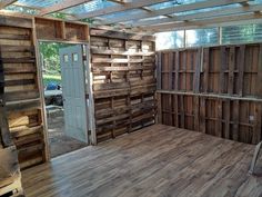 an unfinished room with wood pallets on the floor and walls that have been made out of wooden planks