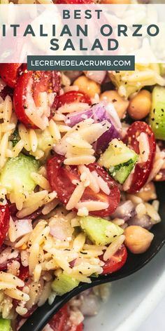 pasta salad with tomatoes, cucumbers and beans in a white bowl