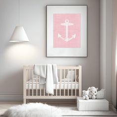 a baby's room with a pink and white anchor print