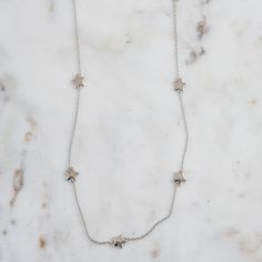 "Super cute and dainty star necklace. It's cute layered or alone. A total of 7 beautifully crafted stars adorn this necklace. -- D E T A I L S -- ▪︎ Made of 925 Sterling Silver ▪︎ Thick plating of 14k Gold or Rhodium ▪︎ Star charm measures 7mm, total of 7 ▪︎ 16\" + 3\" Extension Chain ▪︎ Nickel-free & Hypoallergenic Made with 100% Pure Love! Happy to answer any questions you may have!" Everyday Star Charm Necklace, Dainty Star Necklace For Everyday Wear, Silver Star Print Necklace Perfect For Gift, Silver Necklace With Star Print For Gift, Silver Star Print Necklace For Gift, Silver Star Print Necklace, Gold Star Necklace, Star Necklace Gold, Silver Opal Ring