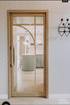 an open door leading into a room with white walls and wood trimming on the wall