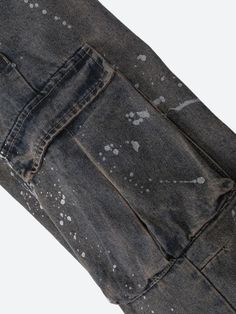 The Stained Cargo Jeans add a grunge-inspired touch with their distressed finish and splattered paint details. Featuring a relaxed, baggy fit, they pair perfectly with crop tops or casual tees for a laid-back streetwear look. Denim material Paint stained design Button & zip fastening Double pockets at front & back Cargo pockets Belt loop detail Low rise Wide leg Cotton, polyester Casual Paint Splatter Streetwear Bottoms, Urban Cotton Bottoms With Paint Splatter, Urban Style Cotton Bottoms With Paint Splatter, Urban Style Paint Splatter Cotton Bottoms, Utility Style Distressed Washed Black Bottoms, Washed Black Distressed Utility Bottoms, Distressed Faded Bottoms For Streetwear, Casual Relaxed Fit Bottoms With Paint Splatter, Faded Distressed Streetwear Jeans