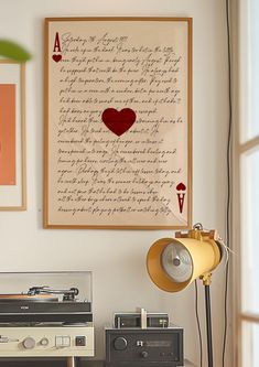 an old record player sitting on top of a table next to a lamp and pictures