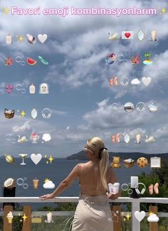 a woman is standing on a balcony looking at the sky and clouds above her head