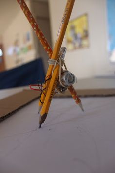 two pencils sitting on top of a piece of paper