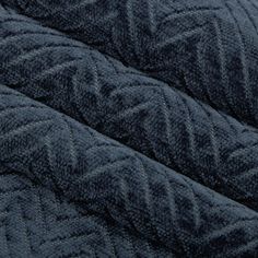 the texture of an upholstered blanket is dark blue