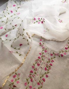 a white table cloth with pink flowers on it