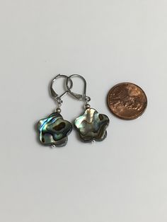 "15mm beautiful abalone shell flower shape dangle earring. Available in silver leverback or silver plated shepherd hook. Dangle 1\" long for leverback, 1.5\" for shepherd hook. You will receive the same par of earrings showing. Hand made Jewelry! Thanks for stopping by! All purchase will arrive in gifts boxes!" Silver Shell-shaped Pearl Earrings For Gifts, Silver Shell-shaped Earrings With Ear Wire, Handmade Silver Shell-shaped Pearl Earrings, Adjustable Silver Shell-shaped Earrings, Handmade Silver Flower Pearl Earrings, Nickel Free Iridescent Mother Of Pearl Earrings, Nickel-free Iridescent Mother Of Pearl Earrings, Iridescent Nickel-free Mother Of Pearl Earrings, Silver Flower-shaped Pearl Earrings