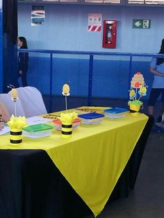 the table is set up with yellow and black decorations for children's birthdays