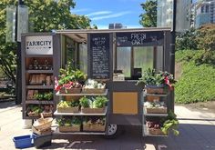 a food truck with lots of vegetables on display