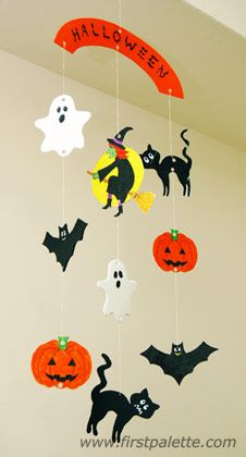 halloween decorations hanging from the ceiling with cats and bats