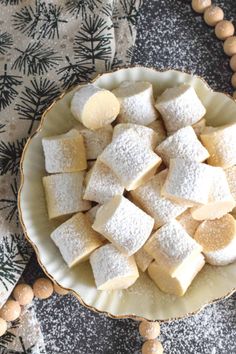 a bowl filled with cut up sugar cubes on top of a table next to beads