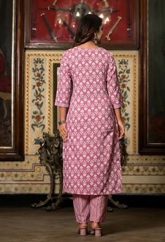 Grab this beautiful 3-piece set. The set comes with straight cut printed kurta has v neck, 3/4th sleeves & calf length teamed with printed trouser pants and a chanderi cotton dupatta to match. Color - Pink Kurta Fabric-Viscose Pant Fabric-Viscose Dupatta Fabric- Chanderi Cotton Neck-V Neck Sleeves-3/4th Sleeves Work - Print Detailing Washing Instructions-Dry Clean Model Height - 5.5 wearing size small. DISCLAIMER - The color of the product may be differ due to screen settings of device. A misprint here and a colour drop slip there is the beauty of printing which is not treated as a defect. Festive V-neck Printed Kurta, Pink Printed Sets For Diwali, Festive V-neck Printed Sets, Pink V-neck Kurta With Printed Motifs, Pink Cotton V-neck Sets, Pink V-neck Cotton Sets, Festive Block Print V-neck Set, Printed Straight Kurta Set For Eid, Pink Printed Kurta For Navratri