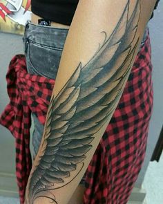 a woman's arm with an eagle tattoo on the left side of her body