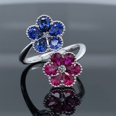 Blue Sapphire & Ruby Precious Petals Ring 1.24ct TW AAA Grade Natural Ruby1.30ct TW AAA Grade Natural Sapphire 18K White Gold Perle framed blossoms of AAA grade natural rubies and sapphires. Diamond centers set in lovely 18k white gold. .10ctw diamond 1.24ctw rubies 1.30ctw sapphires Ruby Jewelry Ring, Ruby And Diamond Ring, Diamond Necklace Set, Earrings Design, Popular Fashion, Yellow Stone, Ruby Jewelry, Stone Engagement Rings, Blue Sapphire Rings