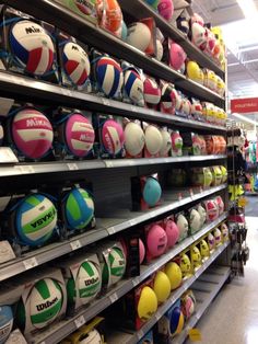 many different types of volleyballs are on display in the store, and there is no image here to provide a caption for