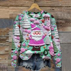 an ugly santa clause sweater hanging on a wooden wall