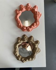 there are two mirrors on the wall next to each other