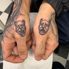 two people with tattoos on their hands holding each other's hands and screaming faces